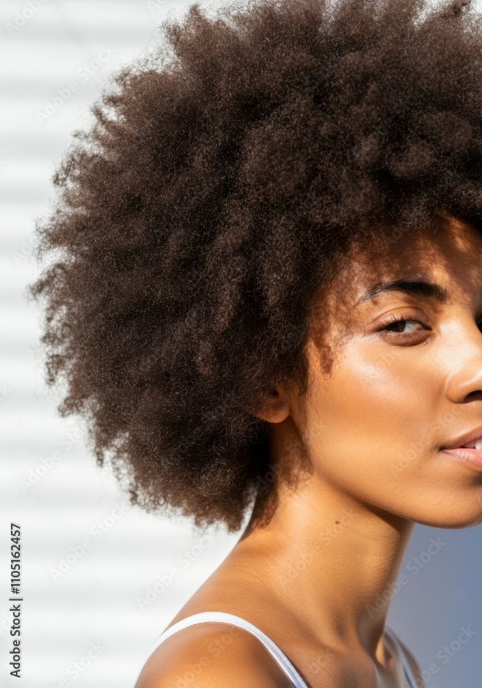 Close-up portrait of young African woman with natural afro hairstyle in sunlight Close-up portrait of young African woman with natural afro hairstyle in sunlight