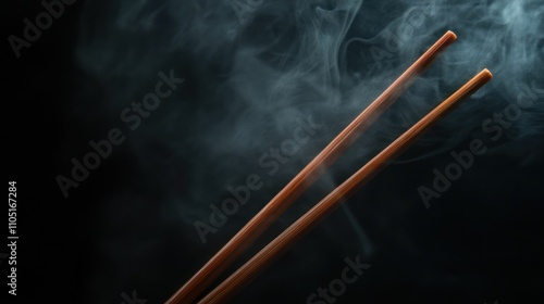 Chopsticks noodles with steam and smoke on black background