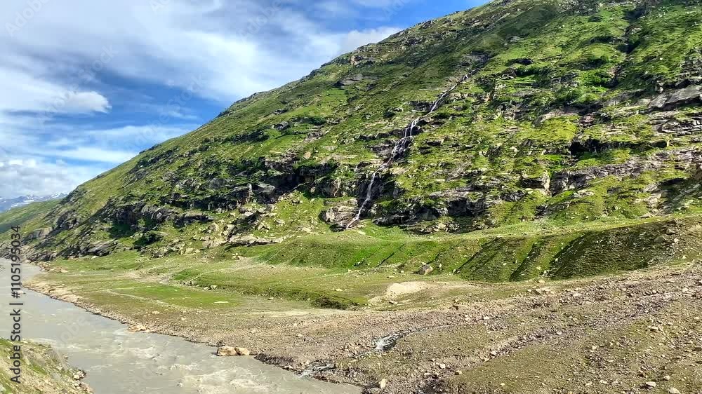 Beautiful view of himalayan mountains and waterfall in the evening at Khoksar in lahaul, leh manali highway himachal pradesh, India Beautiful view of himalayan mountains and waterfall in the evening at Khoksar in lahaul, leh manali highway himachal pradesh, India