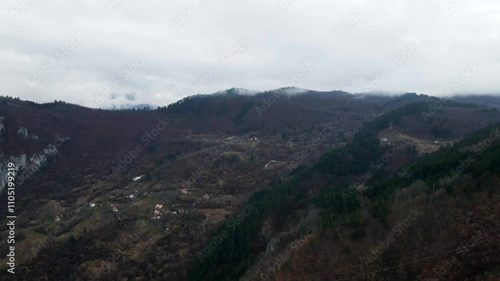Discover breathtaking mountain landscapes in a serene and cloudy setting during early morning hours Discover breathtaking mountain landscapes in a serene and cloudy setting during early morning hours