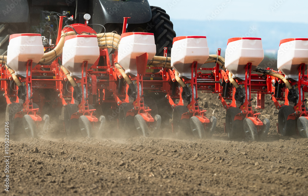 Fototapeta premium Tractor and seeder for sowing corn