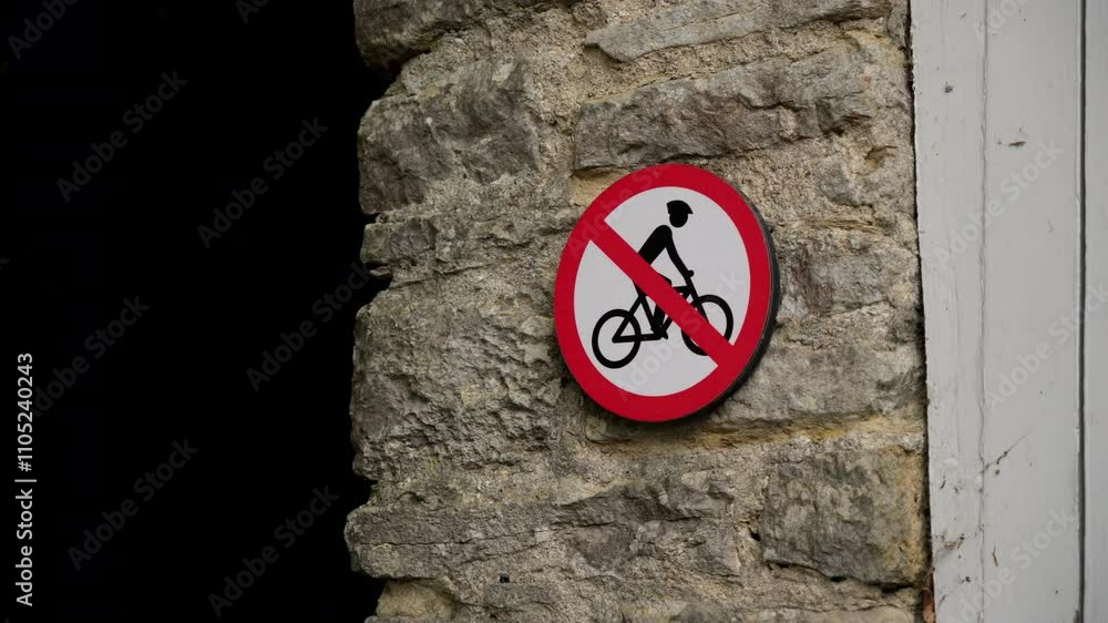 No Bicycles Allowed Sign Displayed Prominently on a Solid Stone Wall for Public Awareness No Bicycles Allowed Sign Displayed Prominently on a Solid Stone Wall for Public Awareness