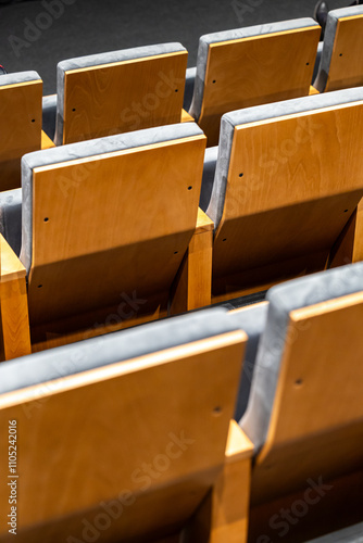 Obraz na płótnie Rows of empty seats in a cinema hall - close-up with shallow depth of field. View of the back part made of light plywood. w salonie