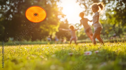 Fototapeta Naklejka Na Ścianę i Meble -  Happy Family Playing Frisbee in a Sunny Park - Joyful Moments of Togetherness and Fun Outdoors