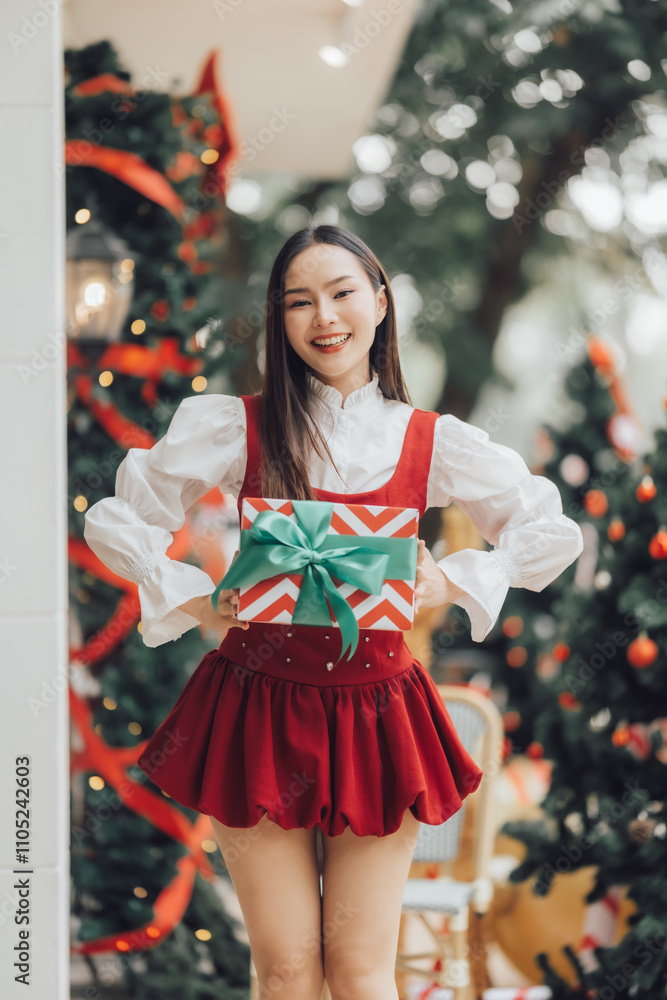 Christmas Cheer: A young woman radiates joy and excitement as she holds a beautifully wrapped gift, standing amidst festive Christmas trees, a perfect image for capturing the spirit of the season. Christmas Cheer: A young woman radiates joy and excitement as she holds a beautifully wrapped gift, standing amidst festive Christmas trees, a perfect image for capturing the spirit of the season.