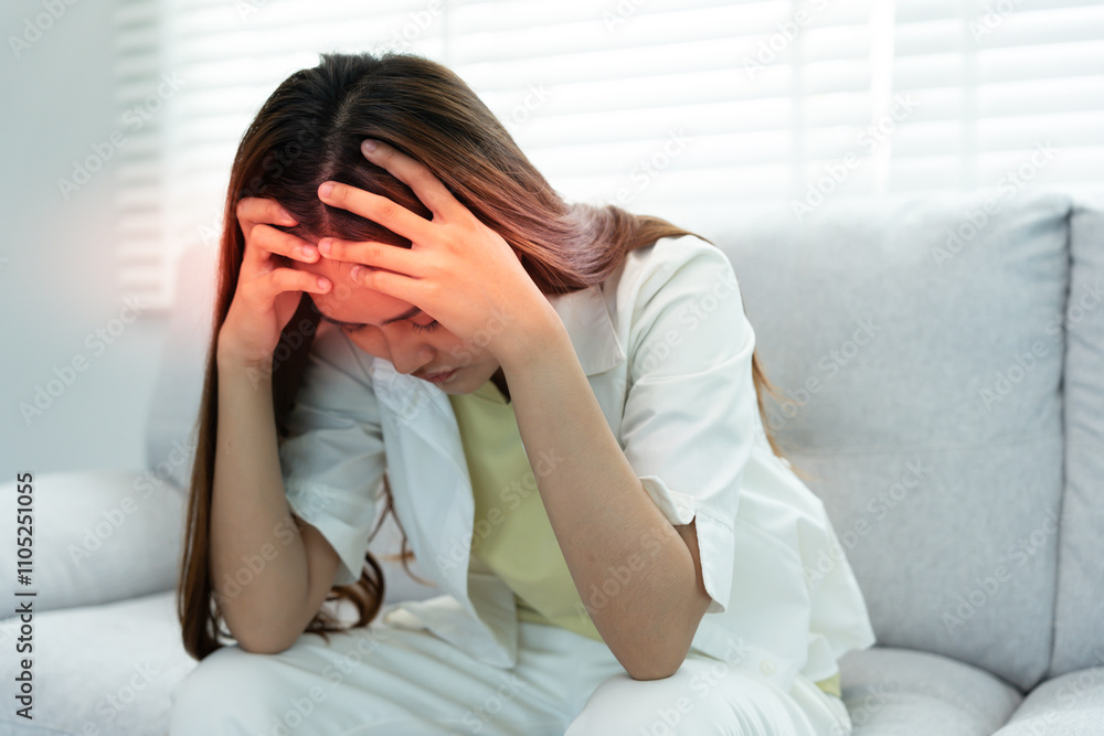 Suffer from headache desperate and stressed because pain and migraine. asian young man suffering migraine pain while working, blue isolated background, brain tumor, high cholesterol effect Suffer from headache desperate and stressed because pain and migraine. asian young man suffering migraine pain while working, blue isolated background, brain tumor, high cholesterol effect