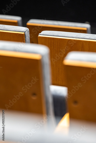 Obraz na płótnie Rows of empty seats in a cinema hall - close-up with shallow depth of field. View of the back part made of light plywood. w salonie