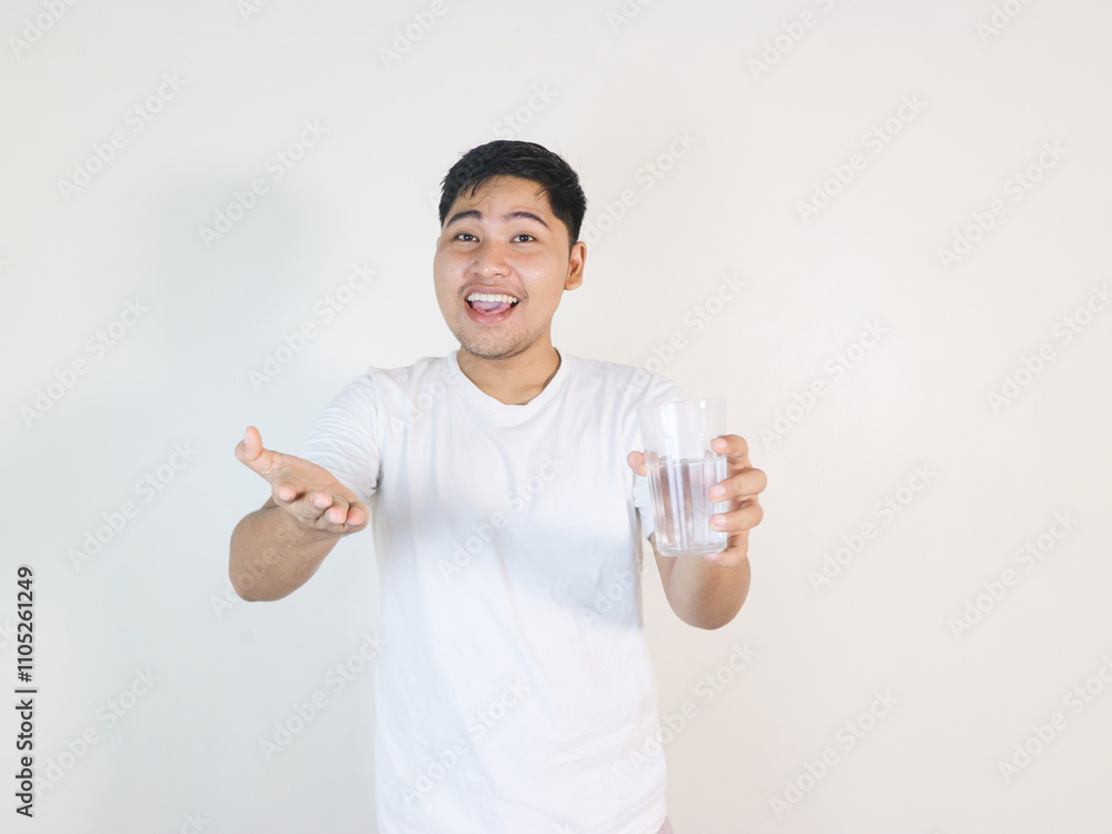 Positive asian man white shirt hold glass of water happy smile isolated Positive asian man white shirt hold glass of water happy smile isolated