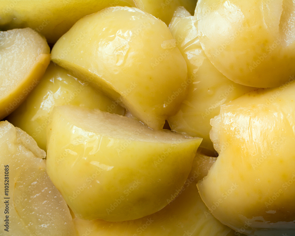 Close-up of yellow canned apple slices. Sweet natural fruits. Close-up of yellow canned apple slices. Sweet natural fruits.
