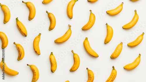 Fresh yellow bananas arranged in a symmetrical pattern on a white background.