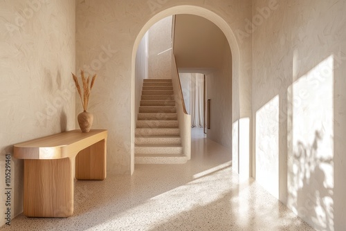 A luxurious hallway with terrazzo floors, natural light, and a stylish staircase.