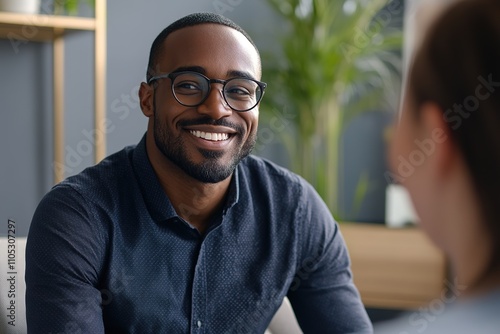 Smiling man in blue shirt having conversation