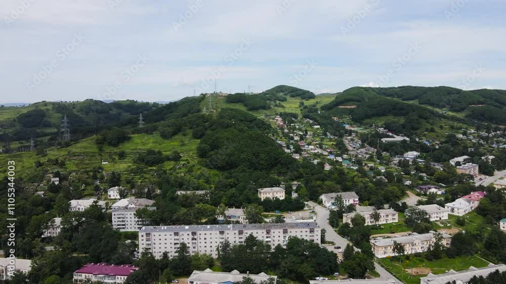 View from above. The camera flies over a small workers' settlement standing on a hill. Workers' settlement in the Far East.