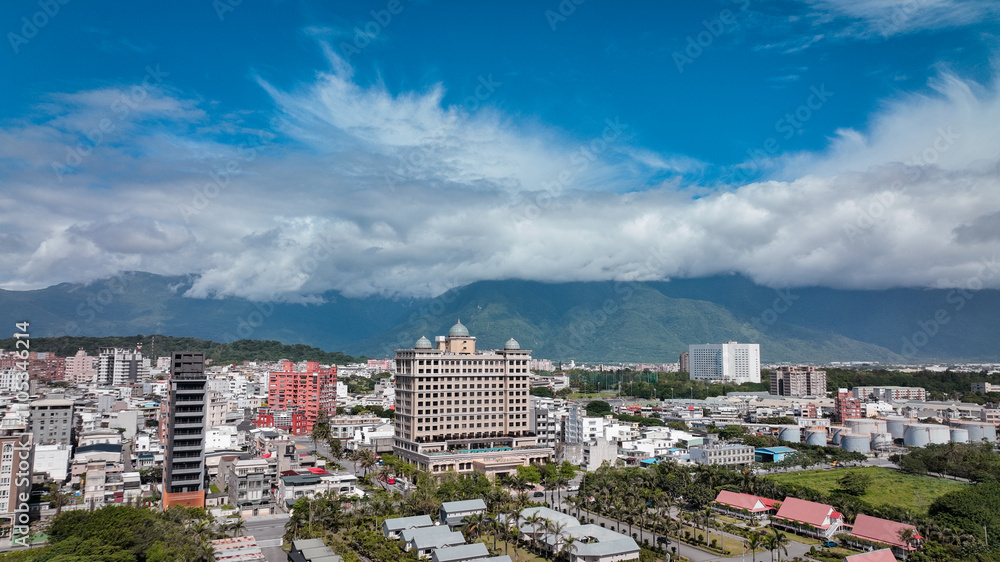 Fototapeta premium Panoramic view of Hualien, Taiwan capturing cityscape and mountains under a cloudy sky