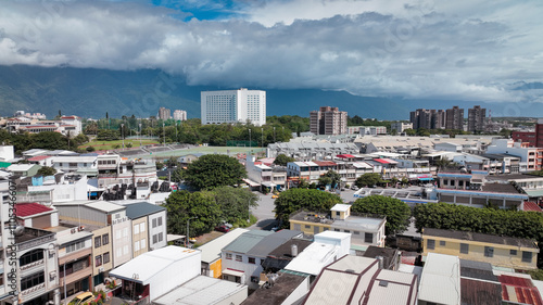 Aerial view of Hualien city with colorful buildings and mountains under a blue sky photo