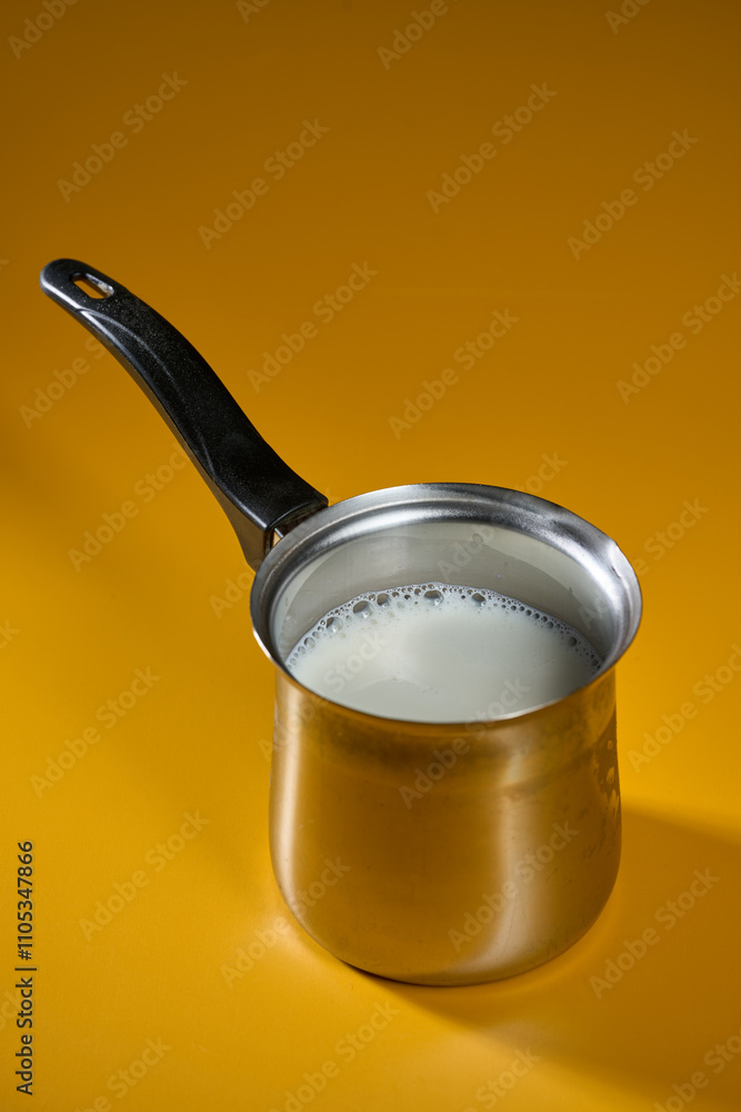 Stainless steel kettle with milk Stainless steel kettle with milk
