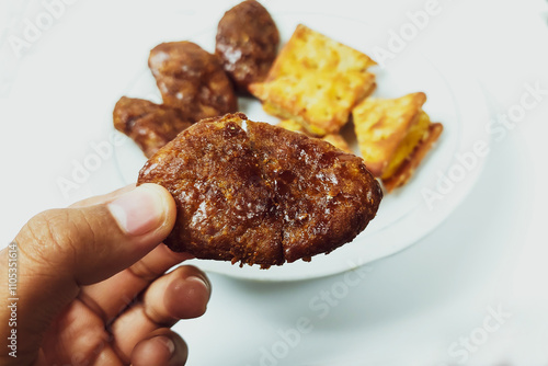 Taripang biscuits and cakes are placed on a white plate on a plain white table photo