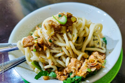 Pangsip noodles on the table and a pair of spoons and forks ready to eat photo