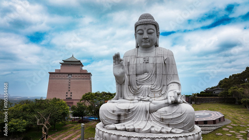 Large seated Buddha statue overlooking a serene landscape in a cemetery in Taiwan