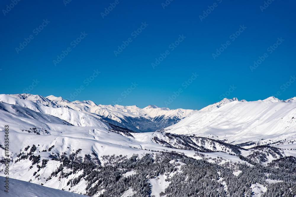 Fototapeta premium Beautiful landscape of the Arkhyz ski resort with mountains, snow, forest on sunny winter day. Caucasus Mountains, Russia.