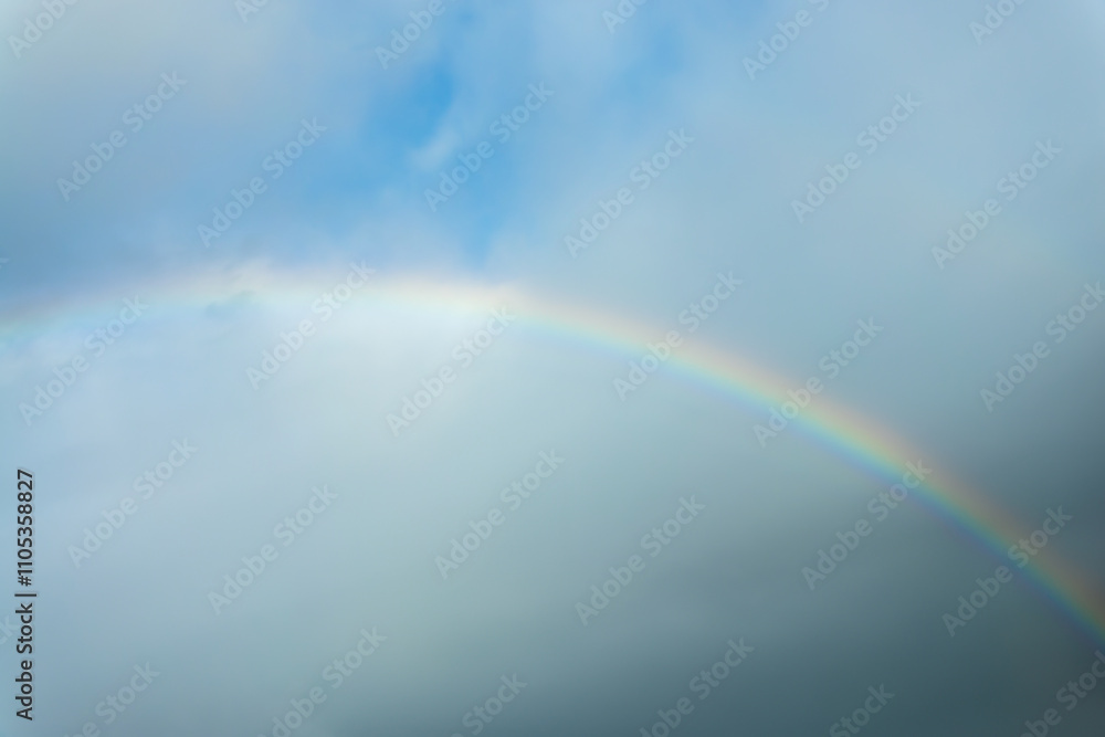 Real photo of a rainbow in the sky with clouds and blue sky Real photo of a rainbow in the sky with clouds and blue sky