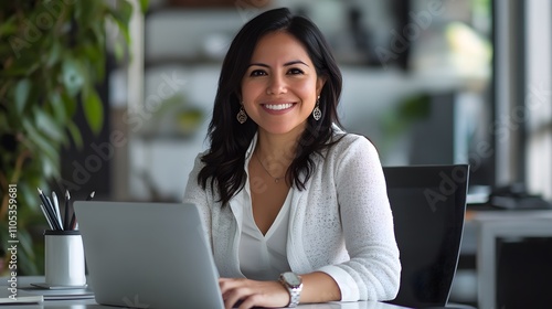 Smiling portrait professional it specialist latin hispanic business lady working on laptop pc sitting in modern office.