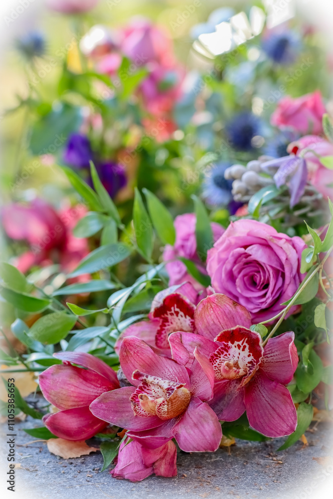 A small funeral flower arrangement. A beautiful memorial bouquet at the cemetery. The memorial flowers include red orchids. A small funeral flower arrangement. A beautiful memorial bouquet at the cemetery. The memorial flowers include red orchids.