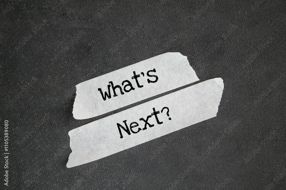© Fauzi - white sticker with the word question What's Next? next step concept