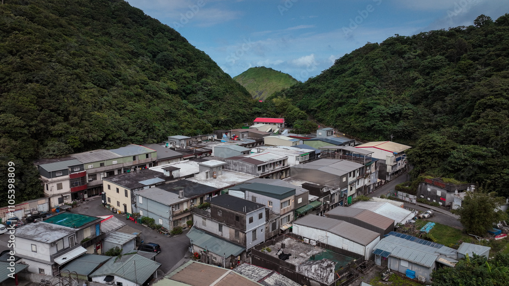 Fototapeta premium Charming mountain village in Nanfangao, Taiwan, with lush greenery and traditional style