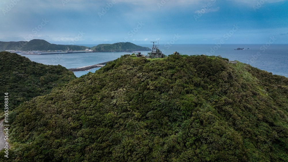 Obraz premium Aerial view of Nanfangaos green hills above the calm coastline and ocean