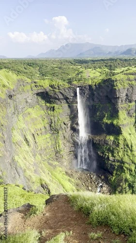 Drone footage of Kalu Waterfall in Sri Lanka in the morning with people on a hill photo