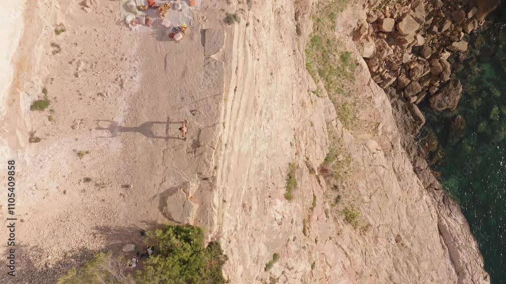 Young Athletic Man Practicing Yoga on a Cliff in Ibiza, Symbolizing Freedom and Balance Young Athletic Man Practicing Yoga on a Cliff in Ibiza, Symbolizing Freedom and Balance