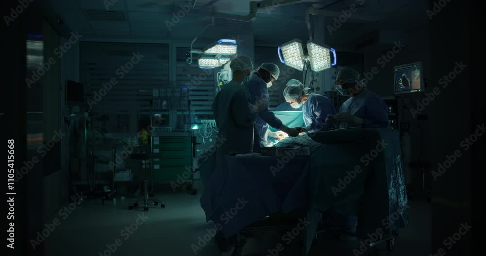 Surgeons and Assistants Perform Delicate Surgical Work. Specialists Staying Calm, Monitoring Vital Readouts On the Screens, Using Advanced Forceps, Graspers and Dissectors to Work on Tissue