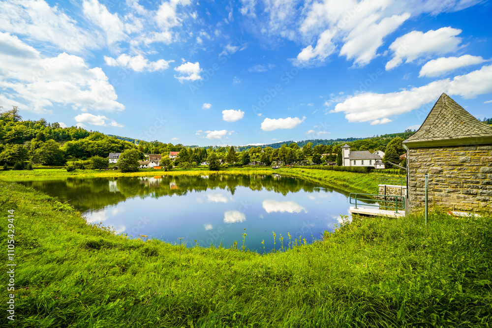 Reservoir on the dam wall at Diemelsee and the surrounding landscape. Nature at the Diemel Dam in the Sauerland.
