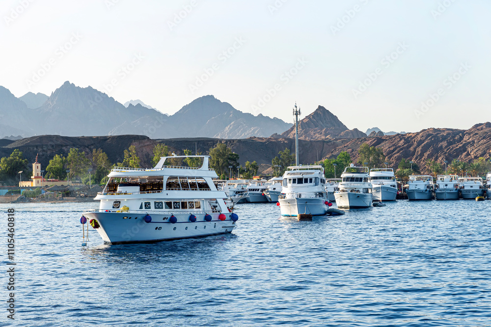 Lot off yachts against backdrop of mountains are anchored in the sea. Marine parking of boats and yachts in Turkey Lot off yachts against backdrop of mountains are anchored in the sea. Marine parking of boats and yachts in Turkey