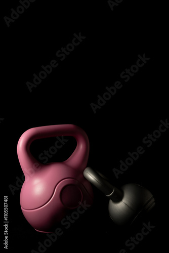 Kettlebells on a black background.