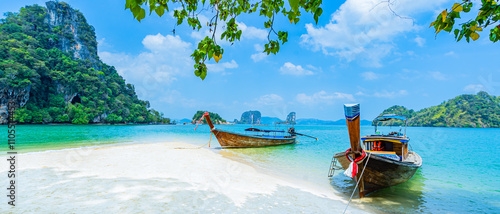 Long-tail boats on a white sandy beach on an island in the Andaman Sea, Krabi Province, Southern Thailand, Asia.