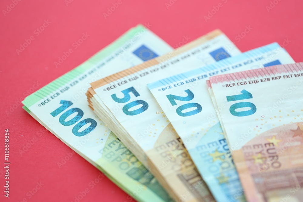 Big amount of one hundred, twenty, ten and fifty euro money bills on red background Big amount of one hundred, twenty, ten and fifty euro money bills on red background