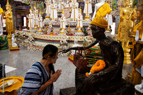 Travelers thai women people travel visit and respect praying blessing make a wish from Luang Phor Joy holy monk statue mystery at Wat Si Uthumphon temple on November 2, 2024 in Nakhon sawan, Thailand photo