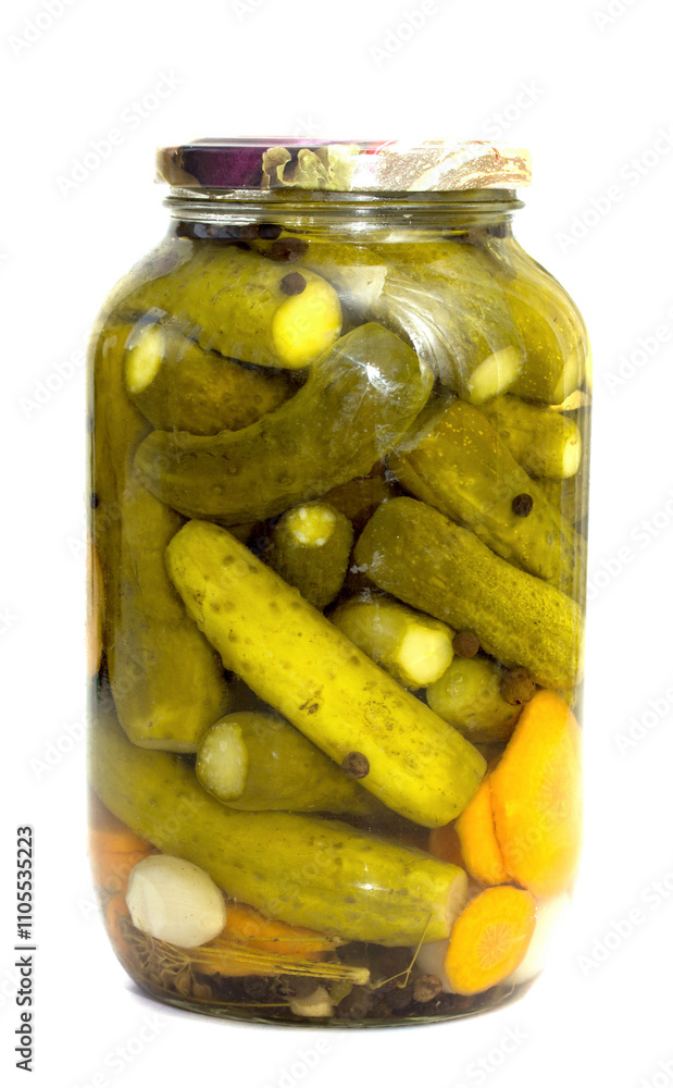 A jar of pickles with carrots and onions inside A jar of pickles with carrots and onions inside