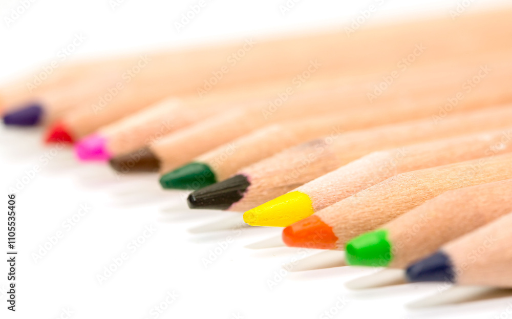 A row of colored pencils with the tip of each pencil pointing up A row of colored pencils with the tip of each pencil pointing up