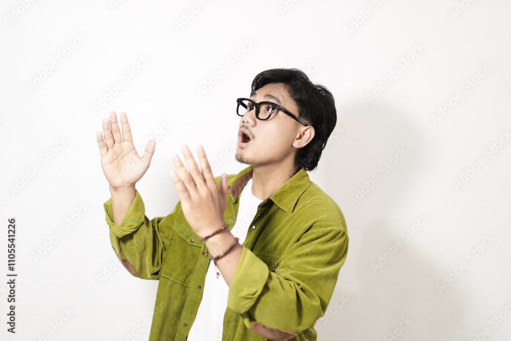Adult Asian man looking above him with surprised expression isolated on white background Adult Asian man looking above him with surprised expression isolated on white background