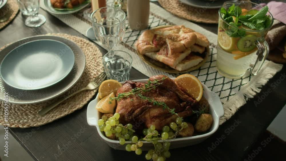 Close-up shot of festive lunch table served with baked chicken and potatoes, flatbread, lemonade Close-up shot of festive lunch table served with baked chicken and potatoes, flatbread, lemonade