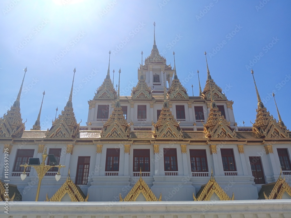 Naklejka premium metal caltle or Loha Prasat in Wat Ratchanatdaram, blue sky