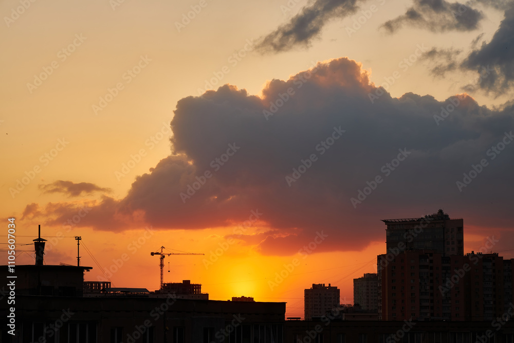 Crane and Buildings Silhouetted Against a Vibrant Sunset Crane and Buildings Silhouetted Against a Vibrant Sunset