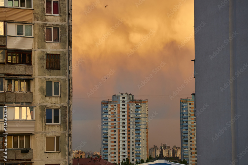 Fototapeta premium Apartment Buildings with Stormy Sky at Sunset