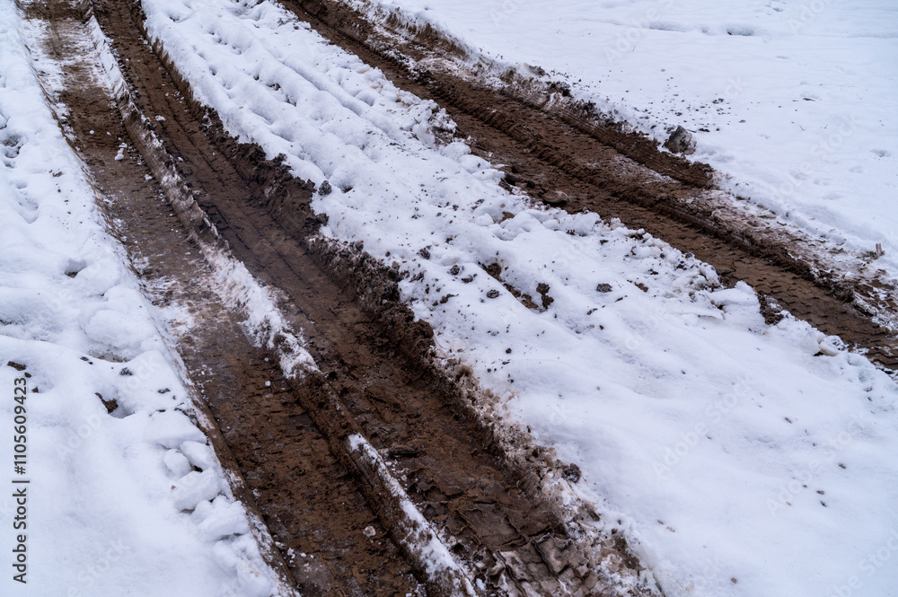 Tire tracks in the ice mud of winter in rural with snow. Off-road in frozen land. Landscape nature background. Tire tracks in the ice mud of winter in rural with snow. Off-road in frozen land. Landscape nature background.