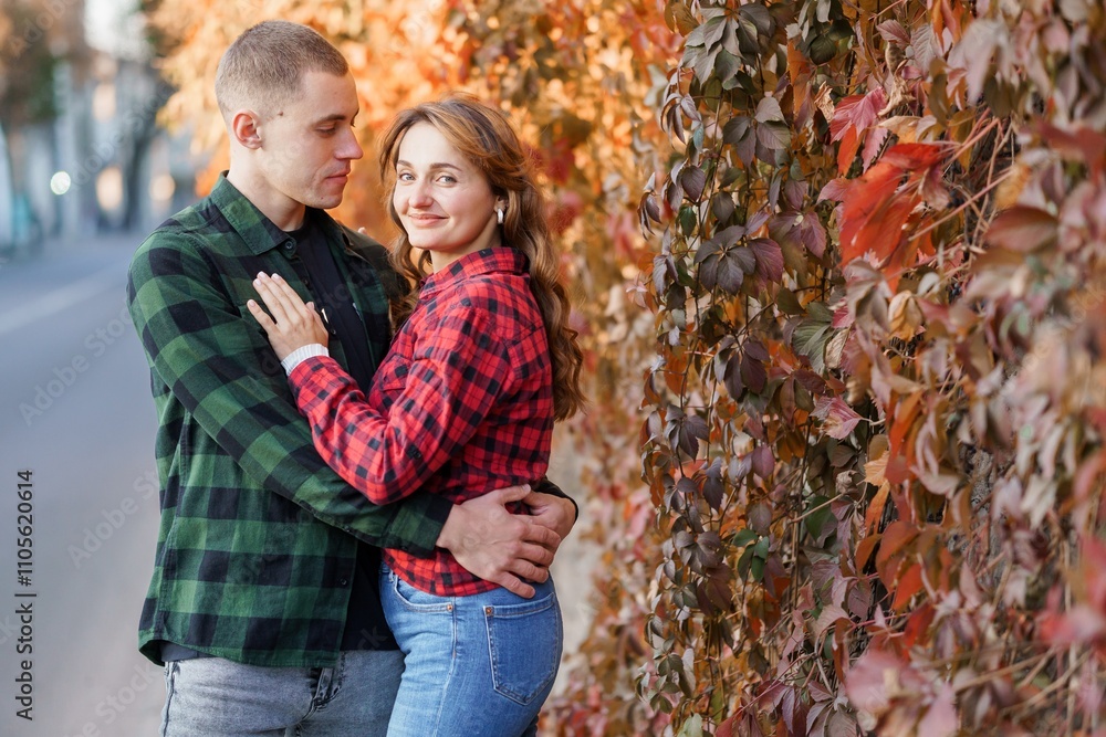 Romantic Autumn Embrace of a Young Couple Surrounded by Colorful Foliage Romantic Autumn Embrace of a Young Couple Surrounded by Colorful Foliage