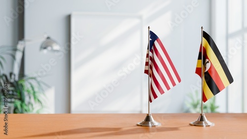 FLAGS OF LIBERIA AND UGANDA ON TABLE photo