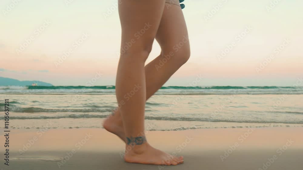 Female legs walking on the beach barefoot. Close up. Female legs walking on the beach barefoot. Close up.